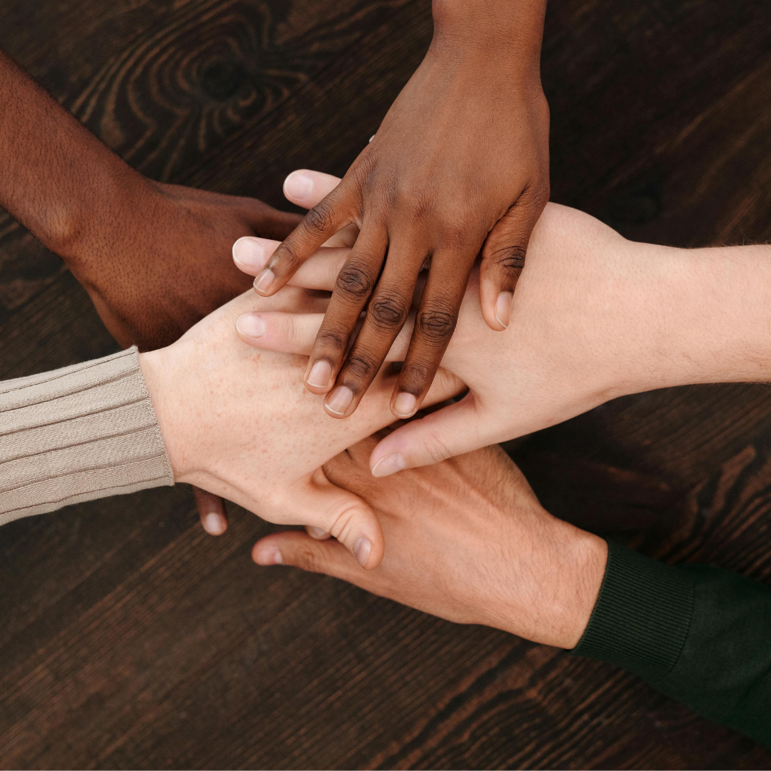Hands join together as a sign of teamwork.
